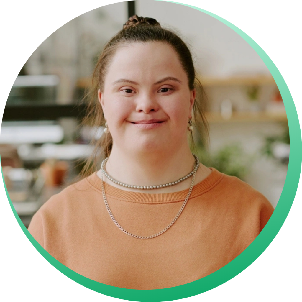 A woman with down syndrome in orange shirt