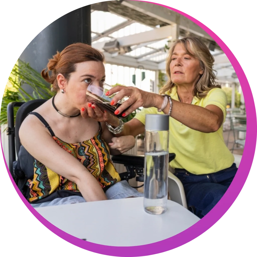 a woman feeding a girl with down syndrome